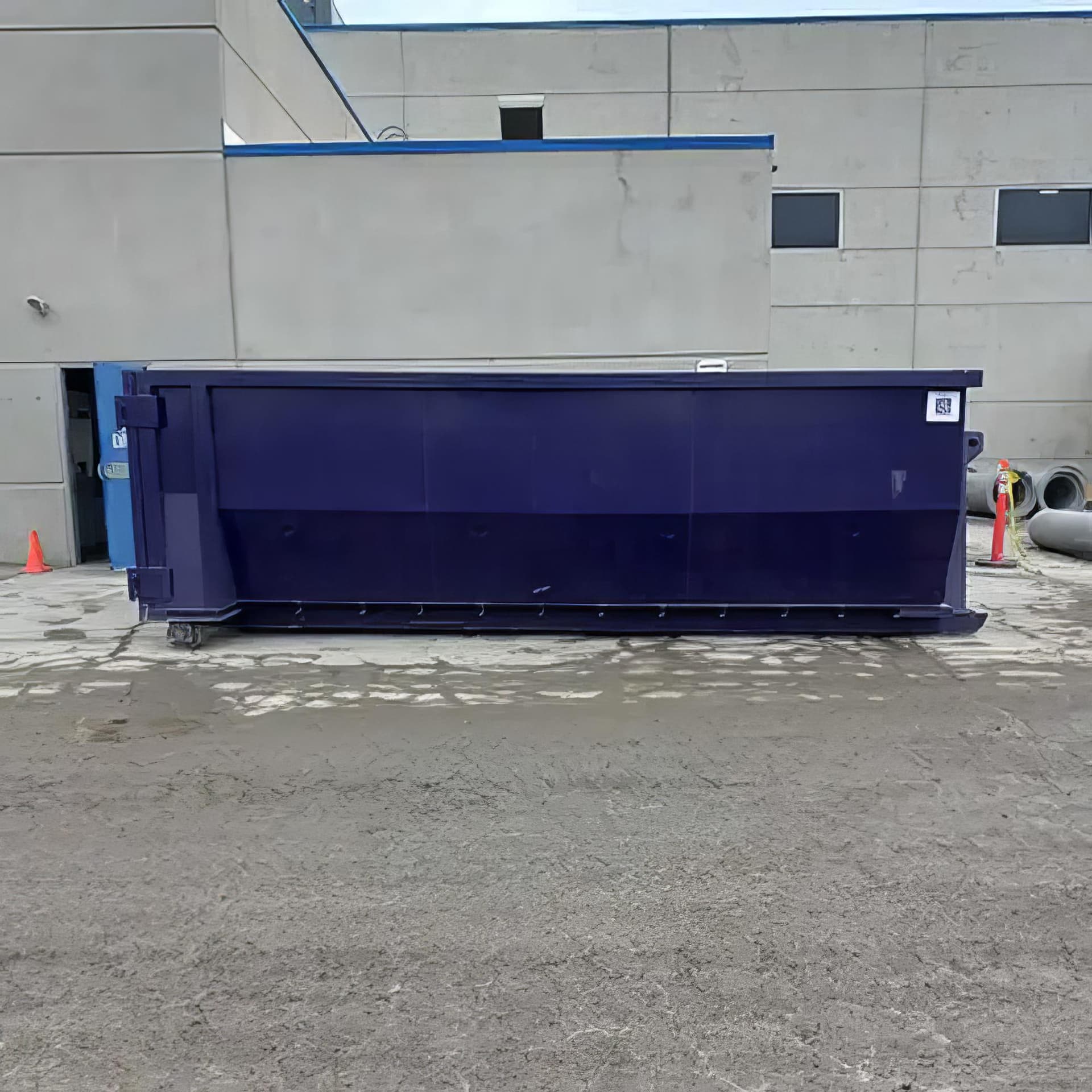 Dumpster with sorted materials and safety signage