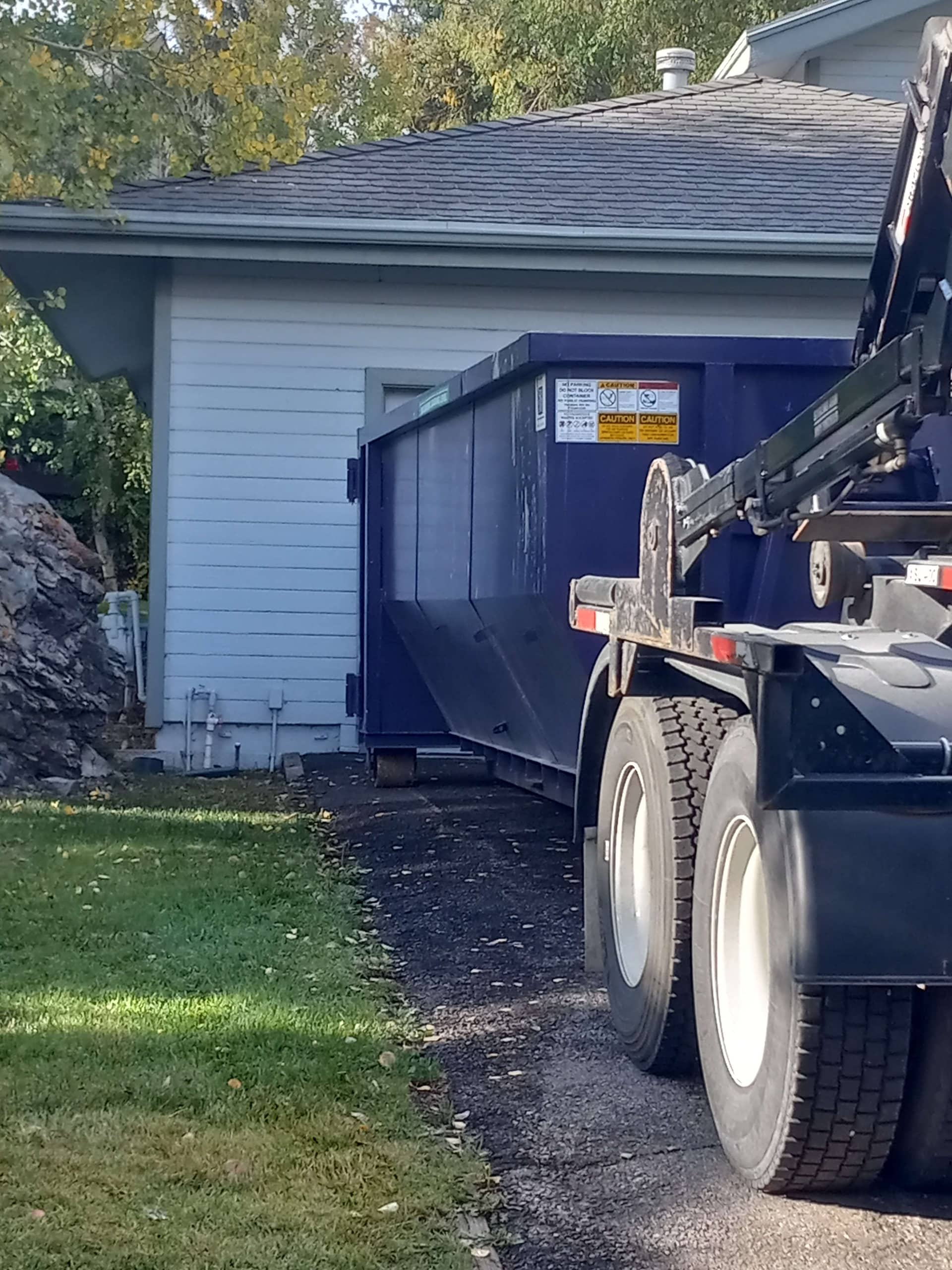 Residential dumpster rental placed on driveway for home renovation and construction debris removal